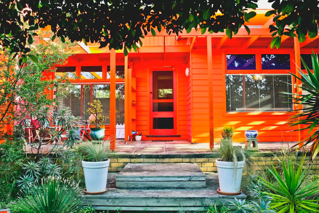 Brightly coloured front porch with dappled sunlight